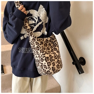 Close-up of plush faux fur leopard print bucket bag with soft texture and shoulder strap