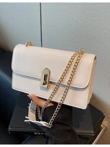Classic cream rectangular shoulder bag with gold chain strap on a minimalist background