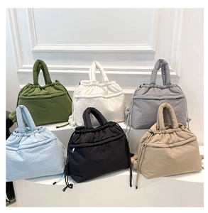 Quilted puffer handbags in various colors with drawstring closure and front zip pockets