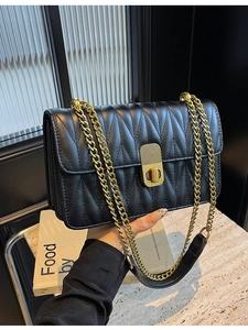 Classic black V-quilted shoulder bag with gold chain strap and turn-lock closure