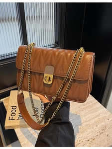 Caramel brown quilted chain shoulder bag with gold twist lock and elegant stitching