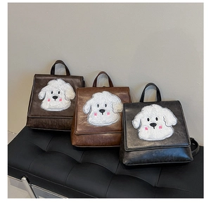 Three retro faux leather backpacks in brown and black with cute puppy appliques