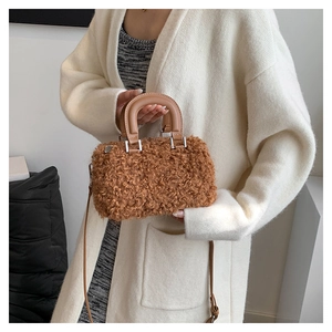Detailed macro view of the brown teddy fleece fabric texture on small crossbody box bag