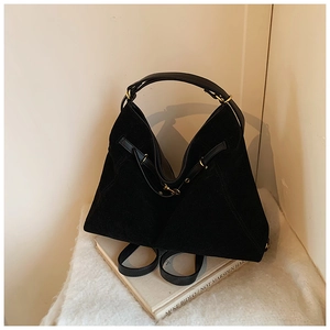 Detail showing matte texture and gold buckle on a black large capacity hobo bag