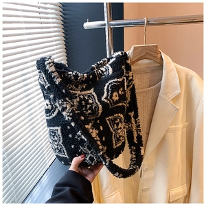 Detailed view of the soft black and white plush tote bag with abstract jacquard pattern