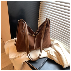 Detail of vintage dark brown tote showing high-quality suede texture and metal buckle