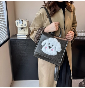 Detail of grey retro backpack with cute plush dog patch shown in a cafe setting