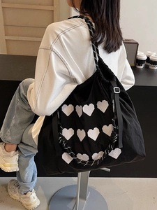 Black high-capacity tote bag with white heart embroidery and braided rope strap