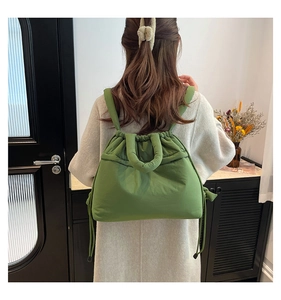 Rear view of matcha green quilted puffer backpack showing soft padded straps and drawstring