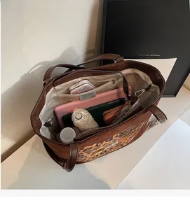 Macro view showing large storage capacity and inner zipper pocket of leopard tote bag