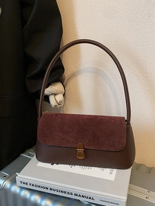Retro burgundy and brown leopard print underarm bag on a stylish silver suitcase