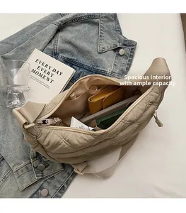 Detailed interior of a beige quilted hobo bag showing large capacity and inner pockets