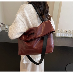 Detailed macro view of burgundy soft PU leather texture and oval handle cutout design