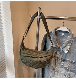 Detailed view of olive green quilted moon bag with diamond stitching and nylon texture