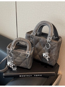Chic grey quilted handbag set with silver balloon dog charm on fashion magazines