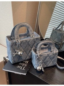 Quilted denim handbag set with silver hardware and balloon dog charm in blue finish