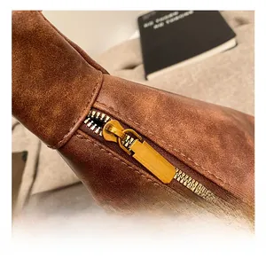 Detail view of premium gold zipper hardware and textured vintage brown leather bag