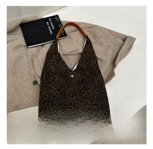 Detailed macro view of leopard print texture, striped lining, and metal button closure