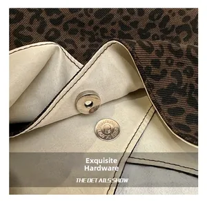 Close-up of the exquisite silver magnetic closure on a leopard print tote bag
