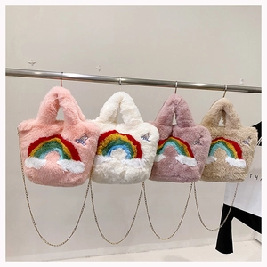 Detailed row of rainbow embroidery plush handbags with cute bunny badges and gold chains