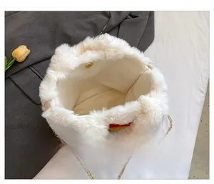 Detailed view of white faux fur bucket bag featuring rainbow patch and gold chain strap