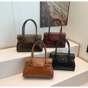 Detailed view of luxury textured leather tote bags in dark brown, wine red and black