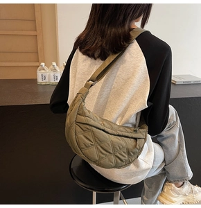 Detail of army green quilted puffer bag showing large capacity and soft nylon texture