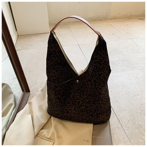 Detail of leopard print hobo bag showing fabric texture and silver round metal buckle