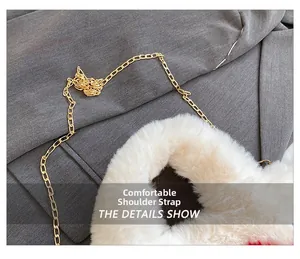 Detail of plush faux fur texture and elegant golden metal chain strap on white bag