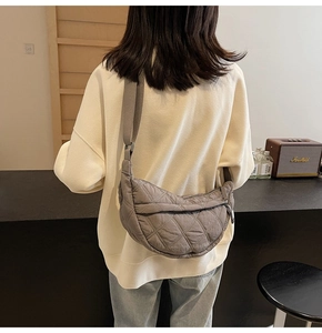 Detailed back view of grey quilted crescent bag with adjustable wide shoulder strap