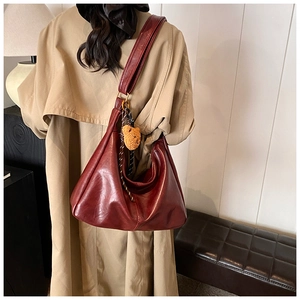 Burgundy retro leather dumpling shoulder bag with cute brown bear charm on the strap