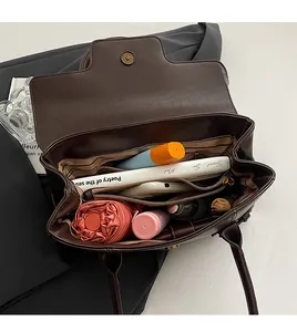 Detail view of large dark brown tote bag interior with multiple storage compartments