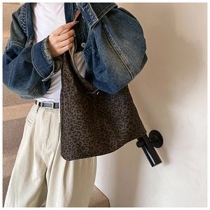 Close-up of leopard print tote bag with large capacity in a street style setting