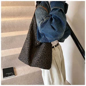 Close-up of leopard print canvas tote bag with slim brown straps and large capacity
