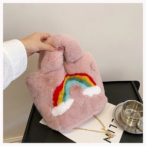 Detail of pink plush bag showing rainbow cloud embroidery and gold metal chain strap