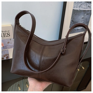 Detailed close-up of dark coffee leather hobo bag showing vintage oil wax texture and zip