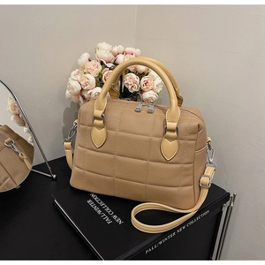 Detail of camel lychee texture leather shell bag with large square quilted stitching