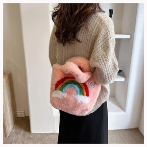 Detail of pink faux fur handbag with rainbow embroidery and gold metal chain strap