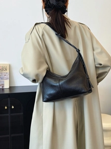 Retro black faux leather crescent hobo bag with vintage texture and sleek shoulder strap