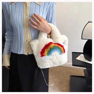 Detail of soft white plush handbag with colorful rainbow patch and bear embroidery