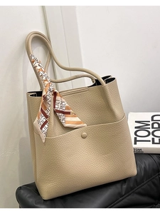 Beige litchi leather bucket bag with geometric silk scarf and long shoulder strap