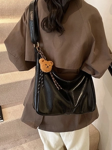 Classic black glossy hobo bag for women with a cute brown plush bear charm accessory