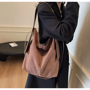 Fashionable large capacity shoulder tote bag in matte mauve leather shown on model