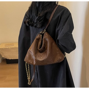 Sac fourre-tout plissé marron vintage avec chaîne dorée et logo M porté par un mannequin