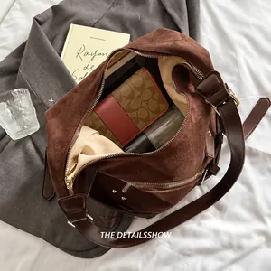 Interior view showing spacious capacity of the brown suede hobo bag with zipper pocket