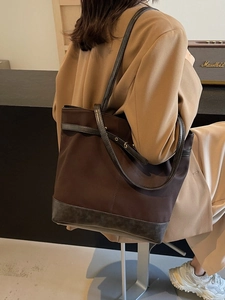 Brown large capacity commuter tote bag with leather straps and nylon fabric finish