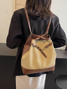 Retro brown leather and canvas large capacity backpack shown on a model in a cafe