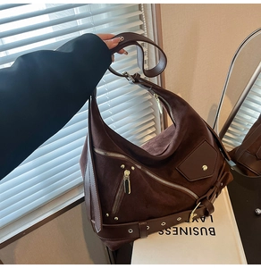 Detail view of dark coffee hobo bag with matte texture and decorative side belt buckle
