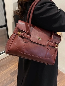 Elegant burgundy leather underarm tote bag with gold metal logo for autumn fashion