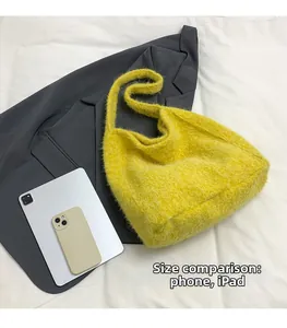 Macro shot of large yellow plush tote bag showing size comparison with iPad and phone